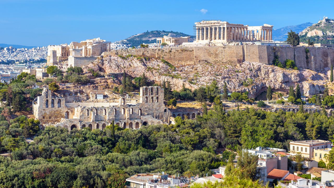 Athens cityscape in summer with the Acropolis hill and the Parthenon rising above the rooftops