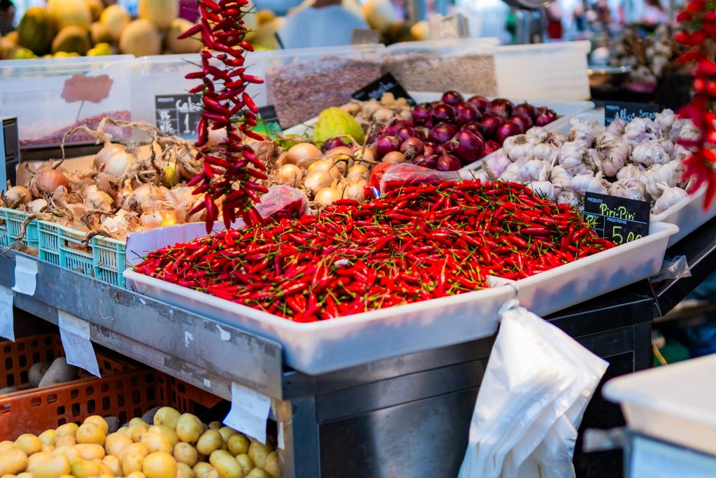 Fruit and vegetable stalls inside the traditional Bolhão market in Porto