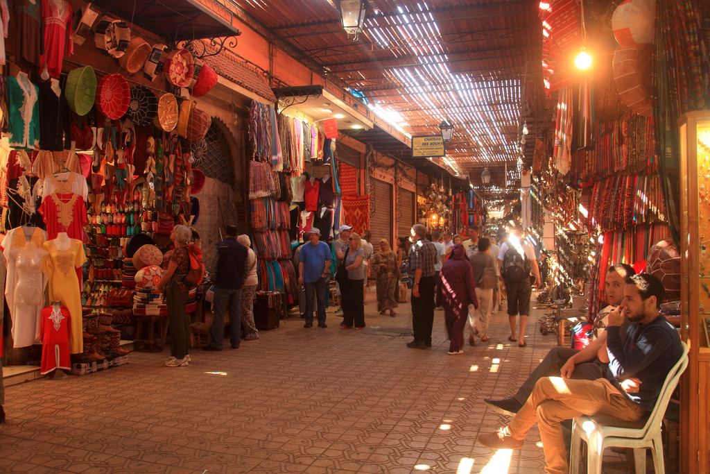 Narrow street lined with stalls in the souk of Marrakech, Morocco