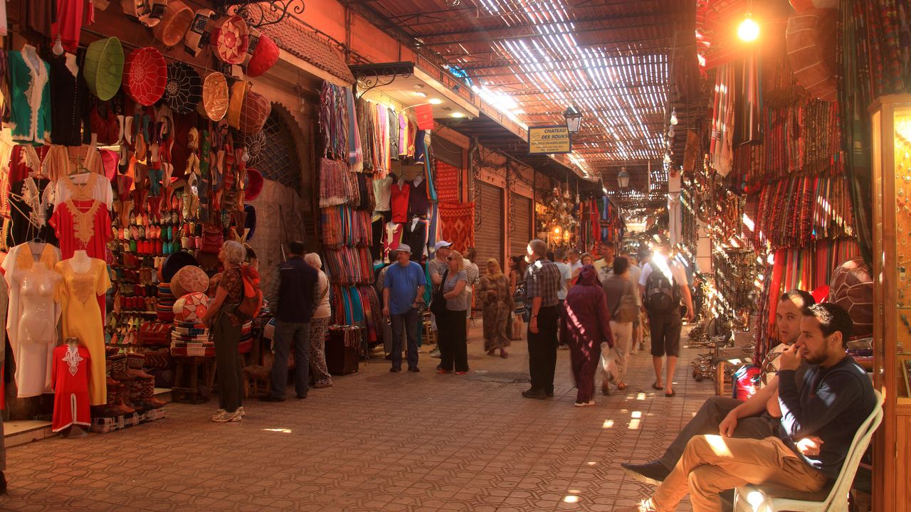 Narrow street lined with stalls in the souk of Marrakech, Morocco