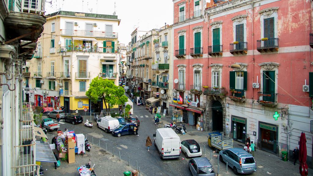 Crowded narrow street in Naples with scooters and people walking