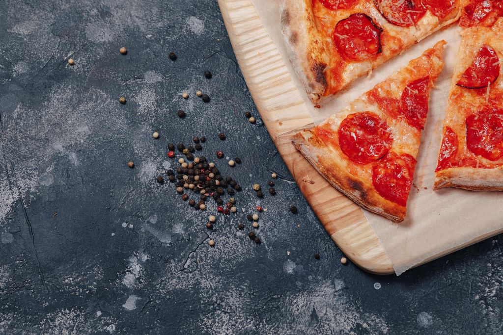 Neapolitan margherita pizza with mozzarella and basil on a wooden board