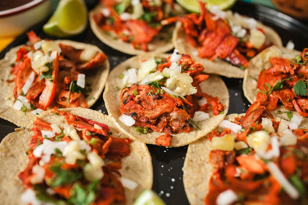 Tacos al pastor being prepared at a street food stall in Mexico City